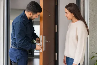 Chaveiro usando ferramentas para abrir uma porta em Itabaiana/SE.